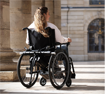 Femme dans un fauteuil roulant avec une motorisation minotor 3 de Benoit Systemes.